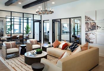 a living room filled with furniture and a chandelier